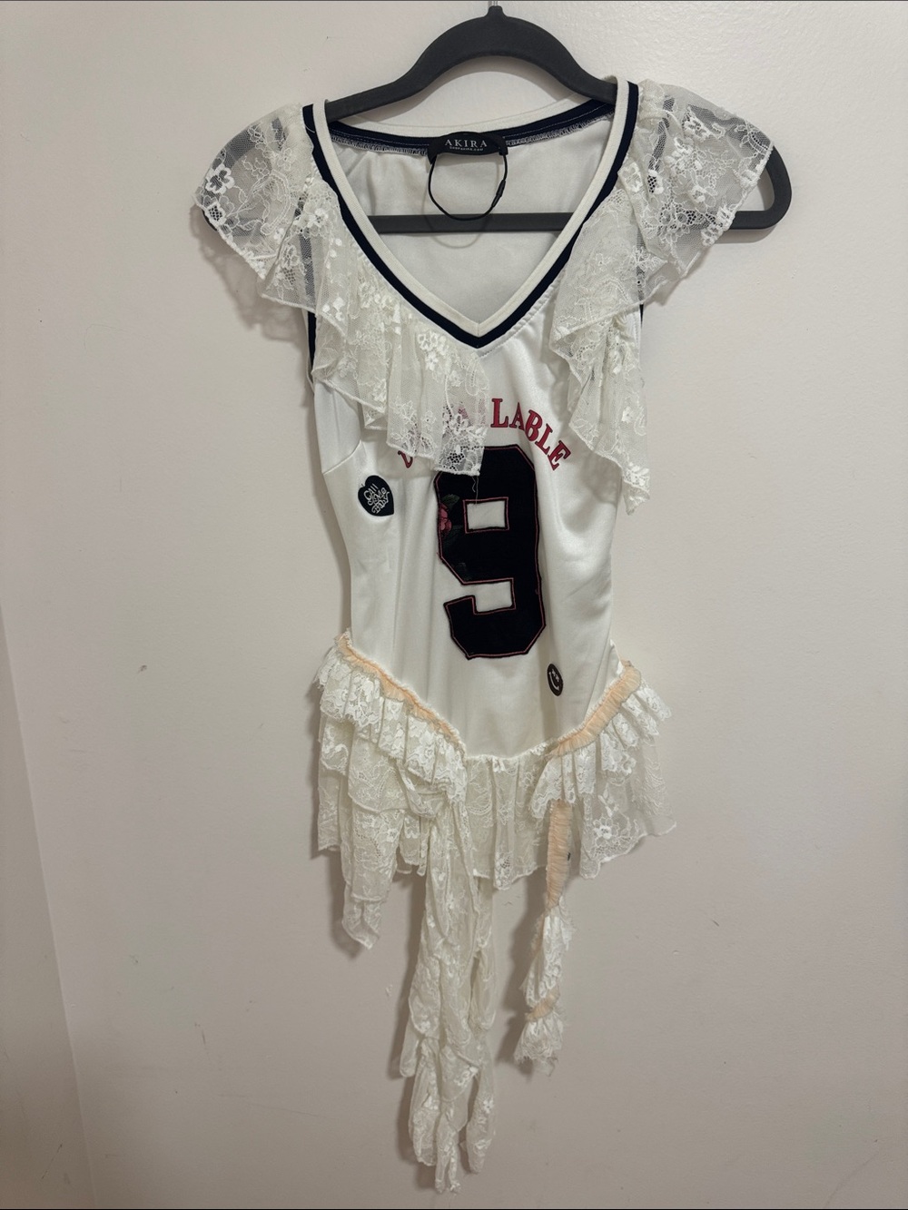 AKIRA White Lace Ruffle Bodysuit with Black Number 9 and Navy Trim